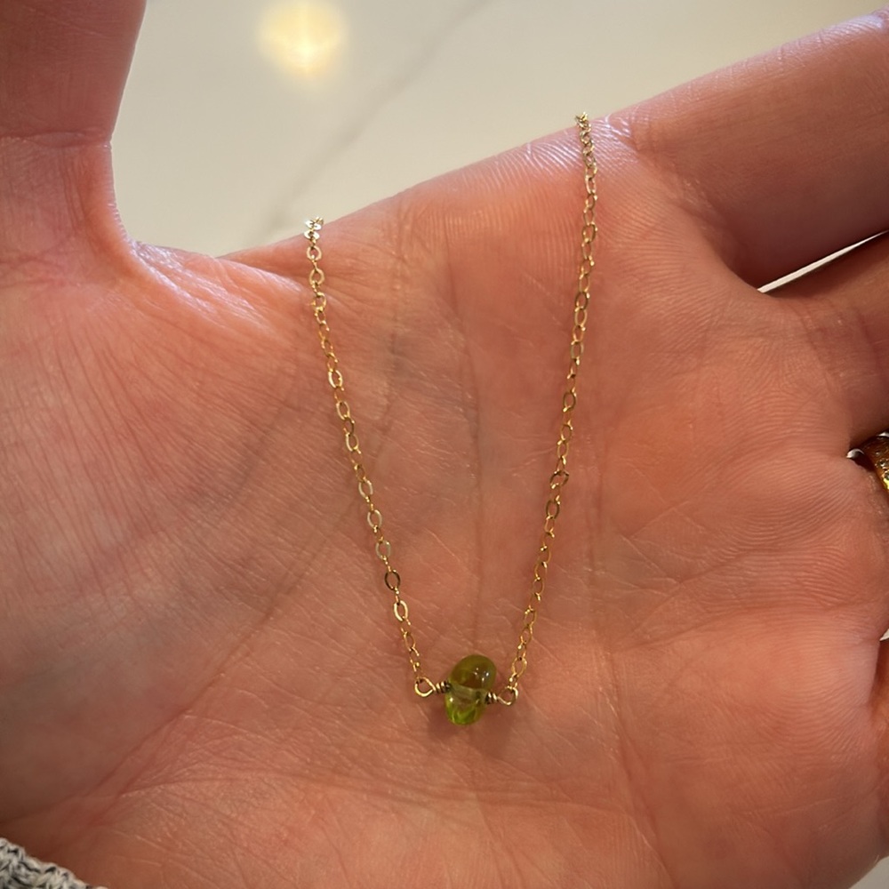 Peridot and gold necklace on link chain. 16 inches